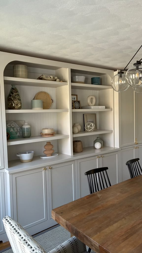 Built-in shelving and cabinets with arched detail