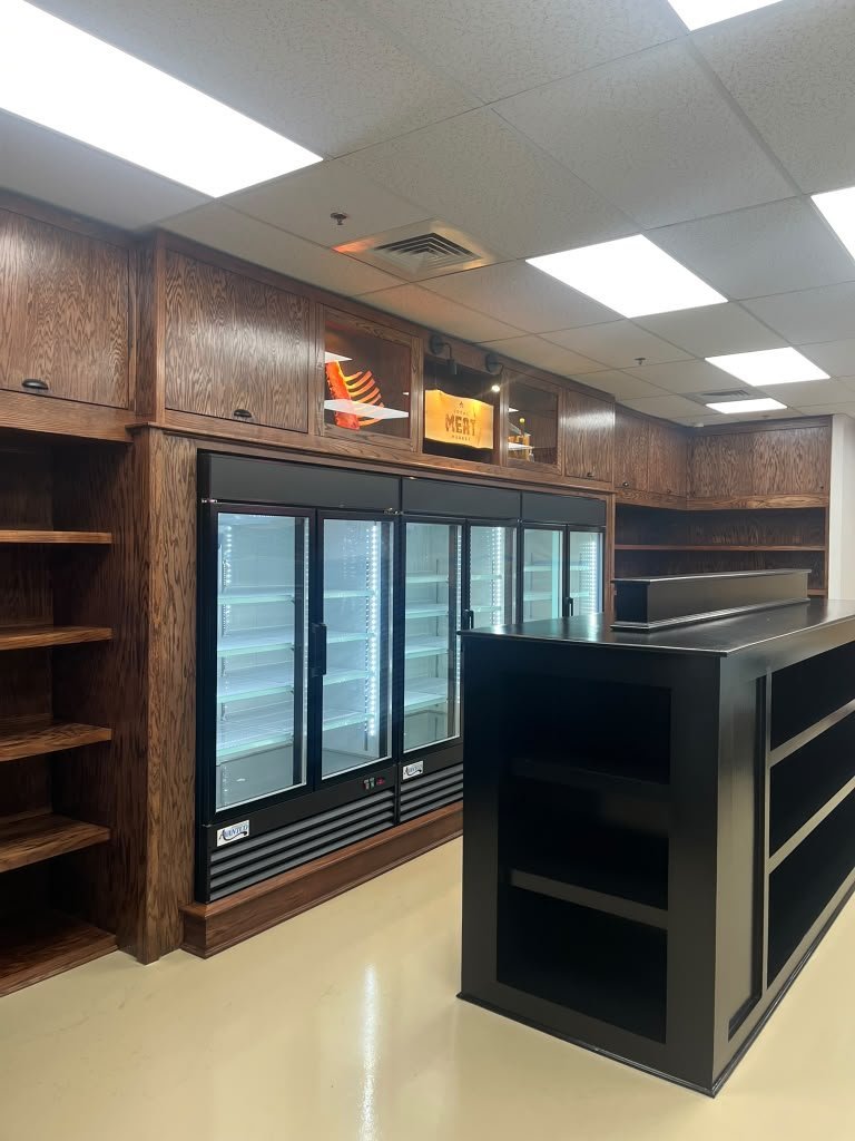 Commercial millwork with display cabinetry and cooler wall