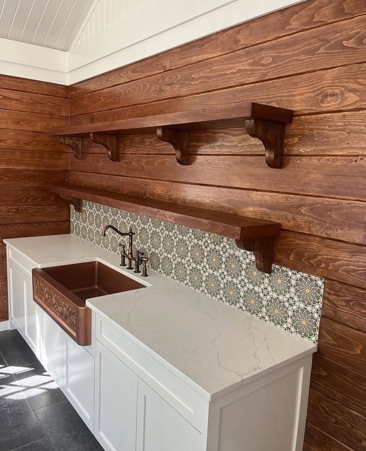 Wet bar with copper farmhouse sink and wood plank walls