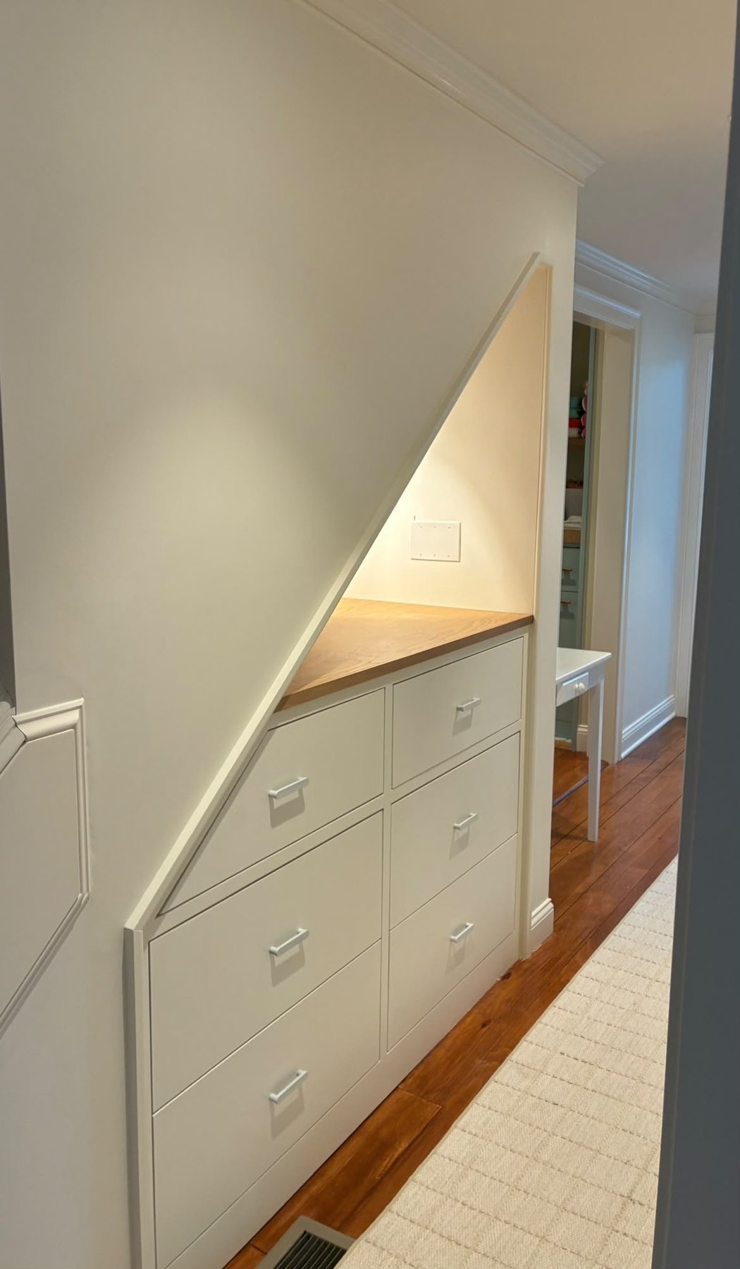 Custom under-stair built-in drawers with wood countertop